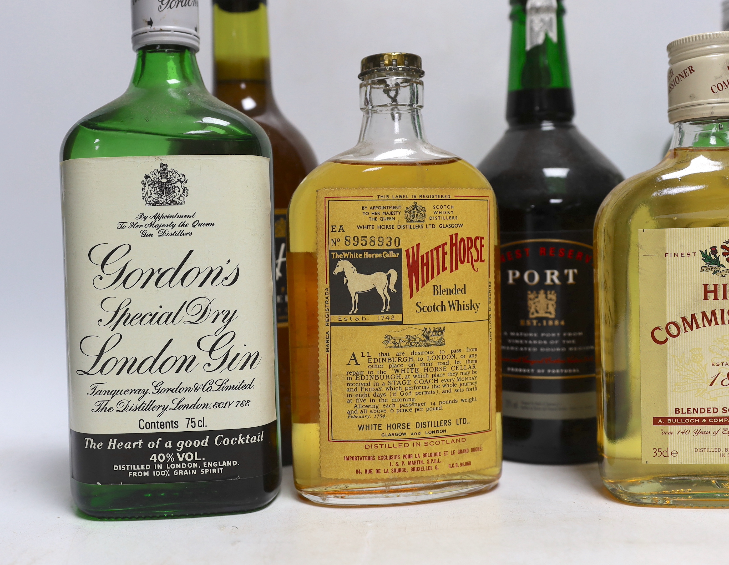 Two 75cl bottles of Gordons gin, two 35cl bottles of whisky, a bottle of sherry and a bottle of port